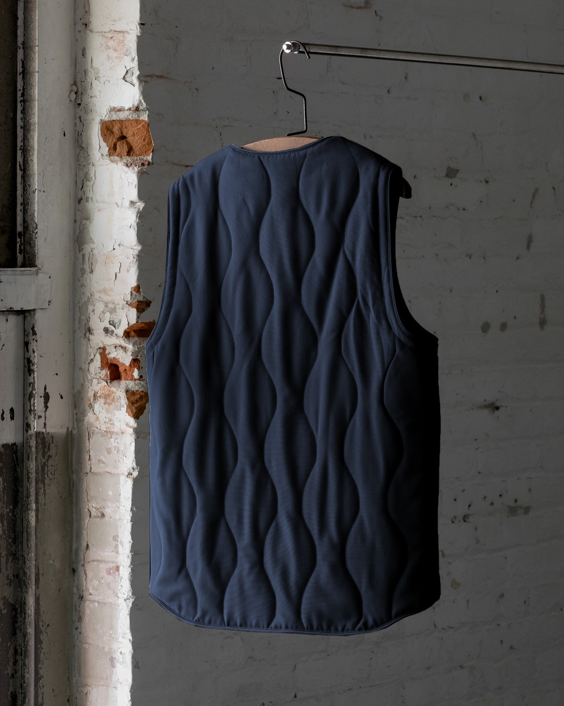 The Mens Quilted Wool Vest in Navy- Back #color_navy