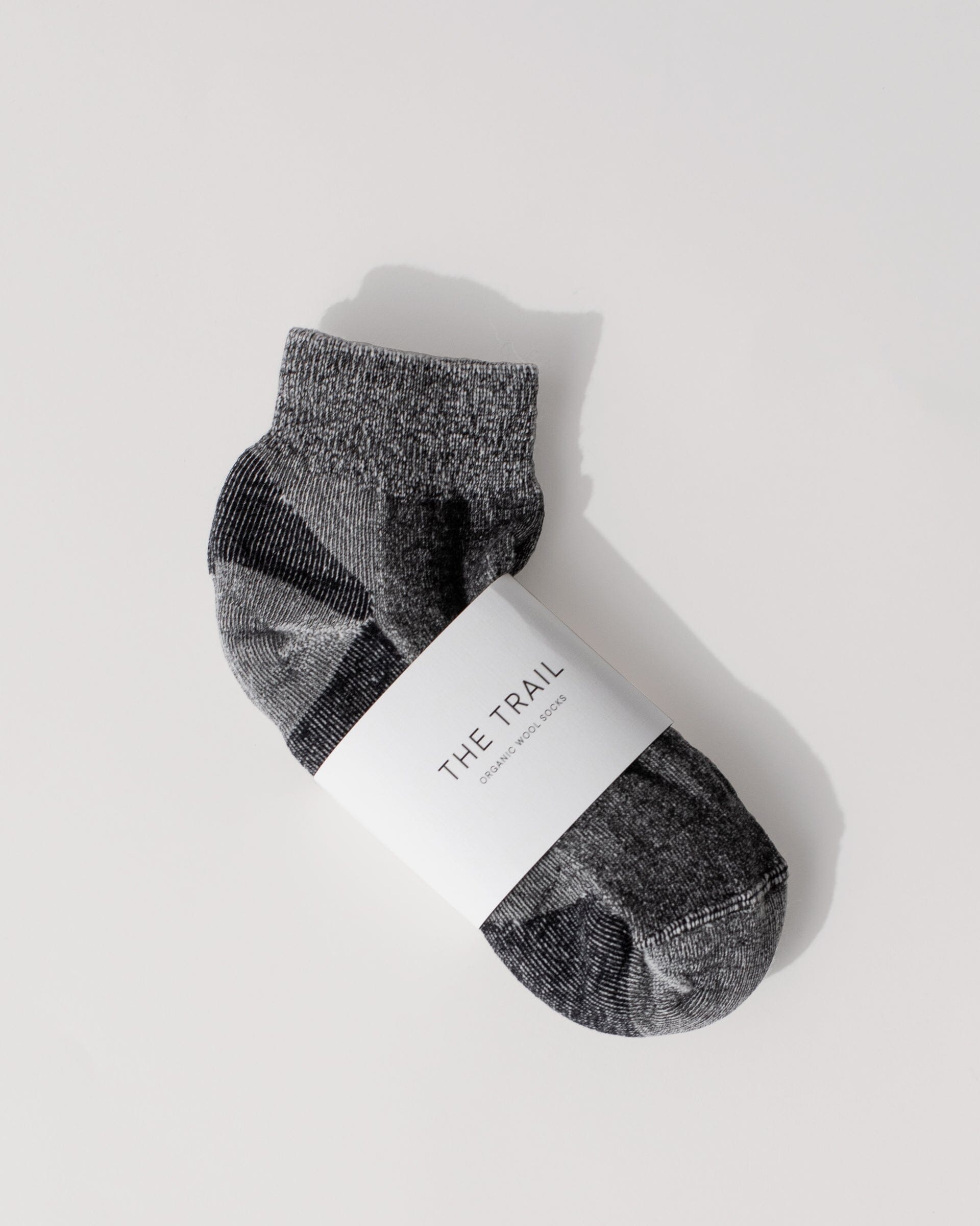#color_black The Trail Sock in Black Flat Lay