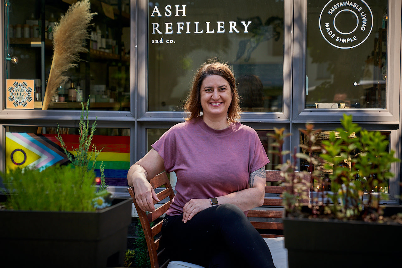 Adrianna Tulissi wears the 195 Dolman in Raspberry while she sits outside her refill store, ASH Refillery